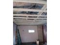 Basement with exposed beams, small window, and a ladder, ready for customization at 4106 N Pasadena Ave, Indianapolis, IN 46226