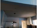 Damaged kitchen ceiling showing repairs needed above the kitchen cabinets and fixtures at 4106 N Pasadena Ave, Indianapolis, IN 46226