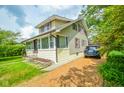 Well-maintained two-story home with classic architecture, complemented by lush lawn and gravel driveway at 4163 Otterbein Ave, Indianapolis, IN 46227