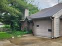 Traditional brick townhome featuring a garage, complemented by a well-maintained yard at 4336 Abby Creek Ln, Indianapolis, IN 46205