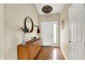 Inviting foyer with wood flooring, a stylish mirror, and a decorative pendant light at 482 Sycamore St, Brownsburg, IN 46112