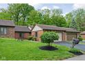 Quaint brick home features a well-manicured lawn and appealing landscaping, enhancing its curb appeal at 5353 Chipwood Ln, Indianapolis, IN 46226