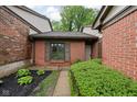 Brick home featuring a landscaped walkway leading to the front door, flanked by lush greenery at 5353 Chipwood Ln, Indianapolis, IN 46226