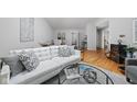 Bright living room featuring a comfortable white sofa, stylish decor, and hardwood flooring at 5353 Chipwood Ln, Indianapolis, IN 46226