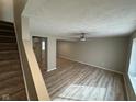Bright living room boasting updated floors and a modern ceiling fan for comfortable living at 5735 Liberty Creek E Dr, Indianapolis, IN 46254