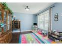 Bright room with light blue walls, hardwood floors, window, and area for children to play at 5913 Monticello Square Ln, Indianapolis, IN 46234