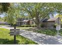 Neighborhood street view of townhome with lush trees, green space, and visible address marker at 601 Conner Creek Dr, Fishers, IN 46038