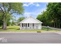 Inviting single-story home with a quaint front porch, fresh exterior paint, and an American flag at 606 E County Line Rd, Indianapolis, IN 46227