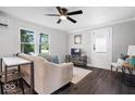 Cozy living room features modern decor, neutral paint, a ceiling fan, and wood-look flooring at 606 E County Line Rd, Indianapolis, IN 46227