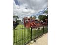 Expansive backyard with a spacious deck, pergola and black metal fence at 6126 Regina Cir, Indianapolis, IN 46224