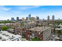 An aerial view captures the downtown skyline behind residential buildings with rooftop details at 630 N College Ave # 105, Indianapolis, IN 46204