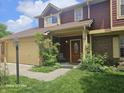 Two-story townhouse with an attached garage, covered entry, and mature landscaping at 6723 Silver Tree Dr, Indianapolis, IN 46236