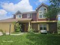 Beautiful townhouse with a covered entrance, attached garage, and lush green lawn at 6723 Silver Tree Dr, Indianapolis, IN 46236