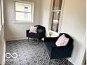 Cozy sun room with patterned tile flooring and comfortable seating at 675 W Morgan St, Martinsville, IN 46151