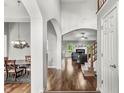 Inviting entryway with hardwood floors, arched doorways, and views into the dining and living areas at 6833 Bluffridge Ln, Indianapolis, IN 46278