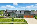 Impressive home with a three-car garage, complemented by professionally manicured landscaping at 7116 Trail Ridge Ln, Indianapolis, IN 46259