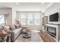 Cozy living room with large windows, plush seating, fireplace and stylish decor at 7258 Selah Ln, Noblesville, IN 46062