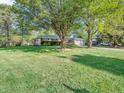 Spacious front lawn with mature shade trees surrounds this lovely ranch-style home at 726 Coach Rd, Indianapolis, IN 46227