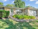 Inviting entryway with a well-manicured garden, adding to the home's curb appeal at 726 Coach Rd, Indianapolis, IN 46227