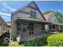Modest two-story home featuring a covered front porch and neutral siding at 811 W 25Th St, Indianapolis, IN 46208