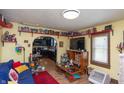 Cozy living room with hardwood floors, custom shelving, and an open layout to the kitchen at 829 Waldemere Ave, Indianapolis, IN 46241