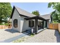 Charming home with a covered front porch and gravel landscaping, offering a blend of comfort and style at 853 S Belleview Pl, Indianapolis, IN 46221