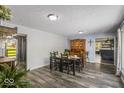 Spacious dining area with hardwood floors, large wooden china cabinet, and decorative lighting at 8581 N Goat Hollow Rd, Mooresville, IN 46158