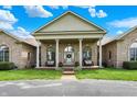 Welcoming entrance with large columns, seating, and a decorative glass front door at 893 W 500 S, Anderson, IN 46013