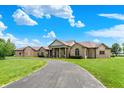 Grand brick home featuring a circular driveway and covered front porch with columns at 893 W 500 S, Anderson, IN 46013