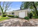 Tan house showing driveway and attached garage at 953 W Clinton St, Danville, IN 46122