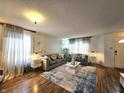 Bright living room showcasing modern decor, a stylish rug, hardwood floors, and contemporary furniture at 10836 Zimmerman Ln, Indianapolis, IN 46231