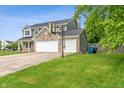 Two-story home with attached garage and driveway at 113 Spring Creek Ct, Noblesville, IN 46062