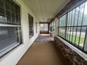 Enclosed front porch with brick accent wall, windows and neutral rug at 1137 W 34Th St, Indianapolis, IN 46208