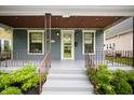 Inviting covered front porch with decorative railing and steps leading to the front door at 117 S Spencer Ave, Indianapolis, IN 46219