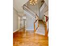 Inviting foyer with hardwood floors, a soaring ceiling, and a staircase leading to the upper level at 12044 Bird Key Blvd, Fishers, IN 46037
