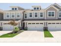Stylish townhouse with a two-car garage, dormer windows, and manicured landscaping at 1237 Langham St, Avon, IN 46123