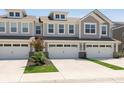 Townhouse featuring a two-car garage and a well maintained lawn at 1237 Langham St, Avon, IN 46123