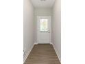 Clean, bright entryway featuring wood-look flooring and a door with a window for natural light at 1280 Newton St, Avon, IN 46123