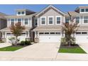 Attractive townhome showcasing a driveway leading to a spacious two-car garage and manicured lawn at 1280 Newton St, Avon, IN 46123