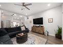 Modern living room featuring hardwood floors, a plush sofa, and a large TV at 1310 Olive St, Indianapolis, IN 46203