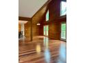 Open living room with high ceilings, wood paneling, hardwood floors, and natural light, perfect for entertaining at 1340 Apache Trl, Martinsville, IN 46151