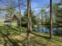 Scenic view of the property highlighting a tranquil pond reflecting the surrounding trees and greenery at 1340 Apache Trl, Martinsville, IN 46151