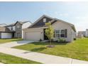 Attractive single-Gathering home with a well-maintained lawn, attached garage and welcoming front entrance at 1483 Paper Birch Dr, Sheridan, IN 46069