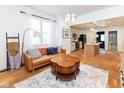 Bright living room featuring hardwood floors and an open layout with access to the kitchen at 1730 Hoyt Ave, Indianapolis, IN 46203