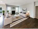 Bright living room with a fireplace, modern furniture, and a striped rug at 18230 Sandy Cove Ln, Westfield, IN 46074