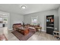 Comfortable living room with neutral walls, area rug, wood-look floors and plentiful natural light at 2229 N Arsenal Ave, Indianapolis, IN 46218
