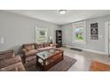 Spacious living room with wood-look floors, area rug and filled with plentiful natural light at 2229 N Arsenal Ave, Indianapolis, IN 46218
