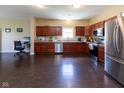 Modern kitchen featuring stainless steel appliances, granite countertops, and ample cabinet space at 2717 Arklow Way, Brownsburg, IN 46112