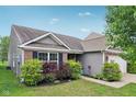 Ranch home featuring landscaped yard, brick accents, and gray vinyl siding at 2911 W Hawanian Ln, Monrovia, IN 46157