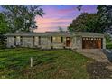 Inviting single-story brick home with lush green lawn, wooden door, and a well-maintained landscape at 2956 N 700 E, Franklin, IN 46131